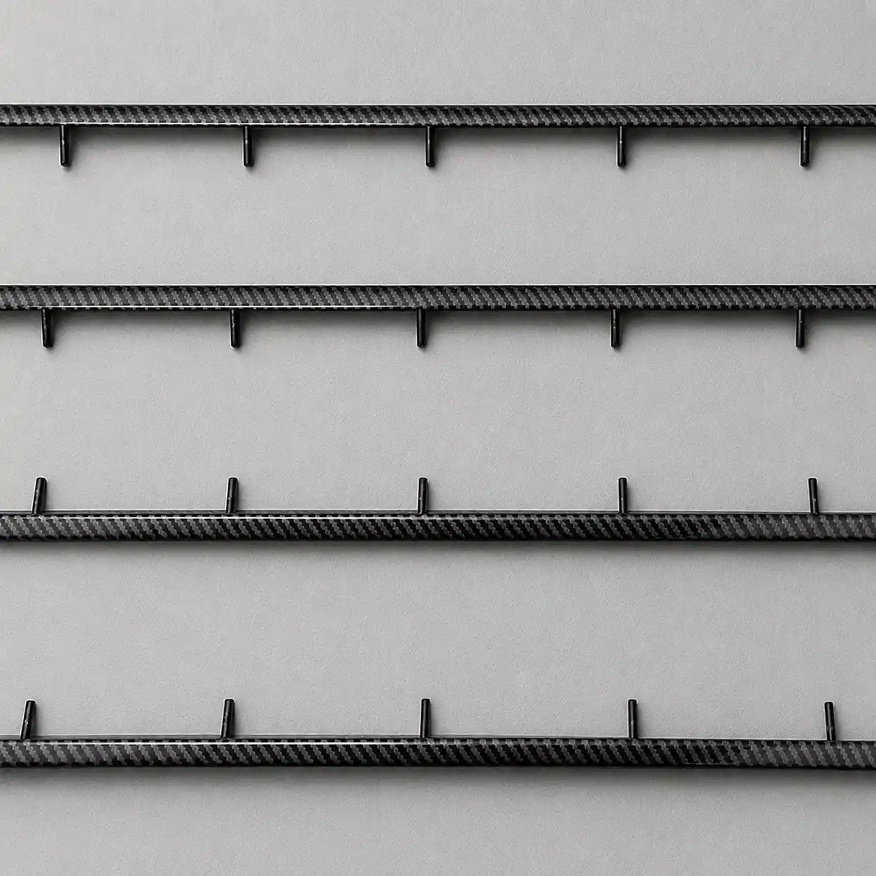 Carbon fiber style panel ambient light trim for automotive interior door lighting, shown on a clean gray textured background.