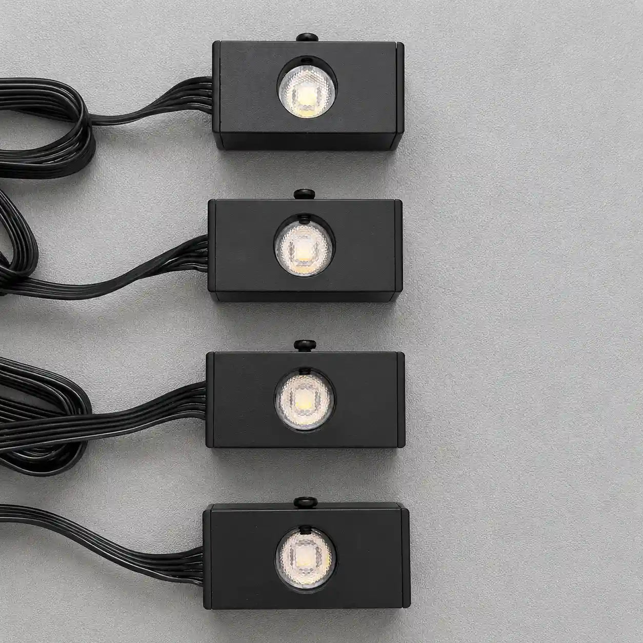 Close-up of four meteor light modules for an automotive fiber optic star ceiling lighting kit, designed to create dynamic shooting star effects.